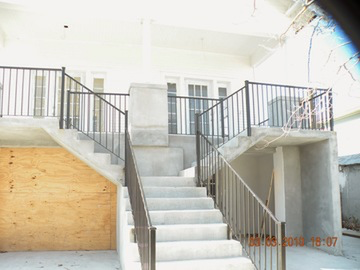 Concrete staircase with iron railings